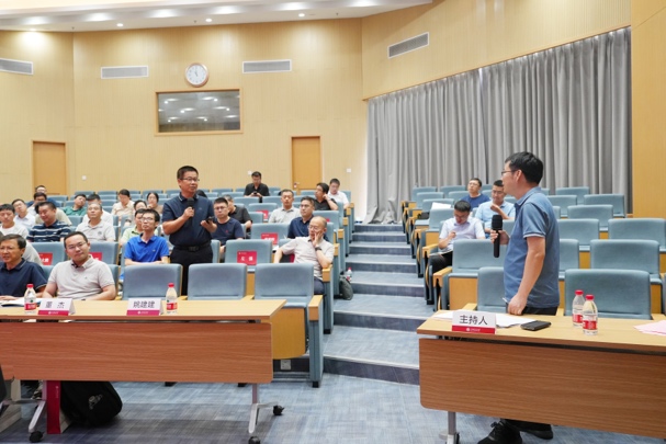 A person standing in front of a group of people
Description automatically generated